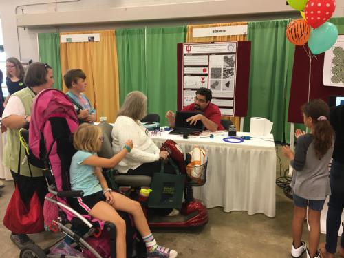 Ye group member describing their presentation to visitors